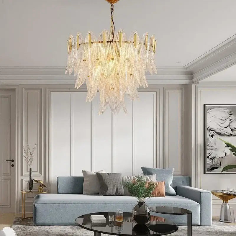 A luxury chandelier featuring decorbites glass leaf translucent pieces and a gold frame for living room lighting
