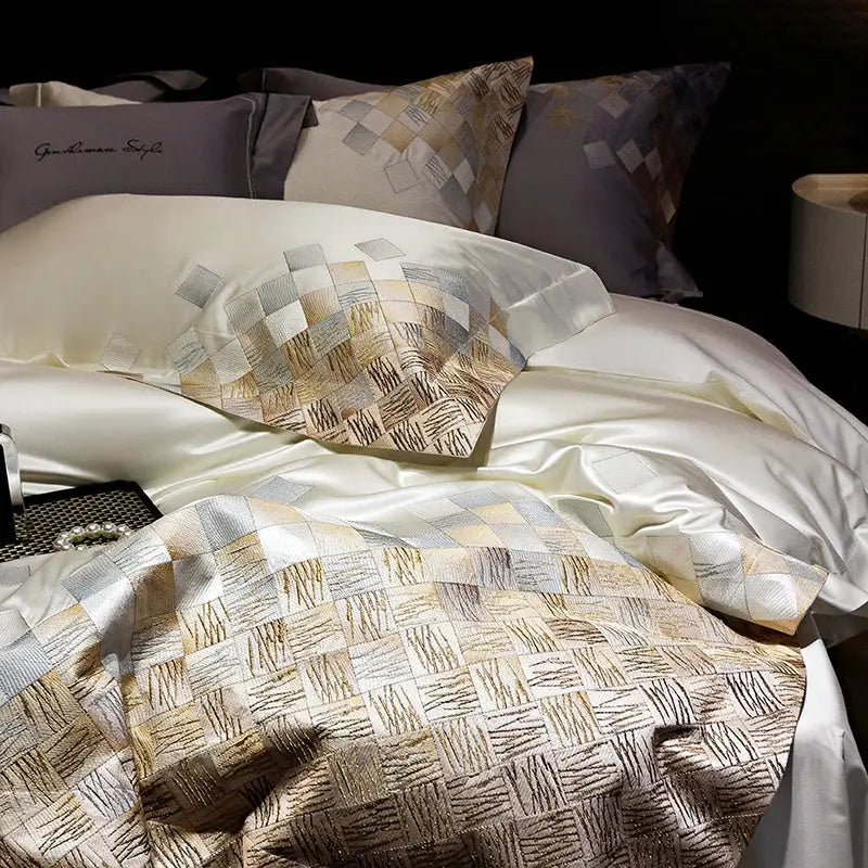 Luxury embroidery bedding set in pearl white featuring a cream satin duvet cover with gold and silver geometric pattern