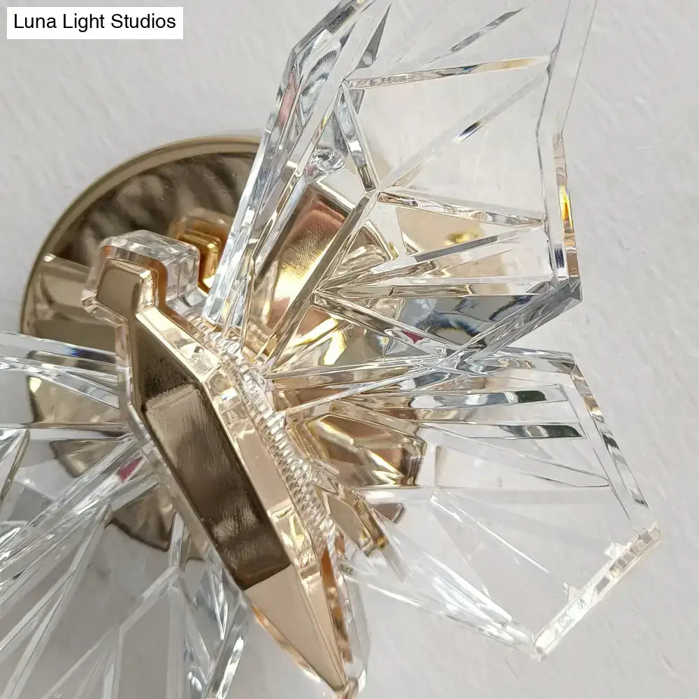 Luxury gold butterfly wall lamp with clear crystal chandelier featuring faceted geometric arms and metal base for bedroom lighting