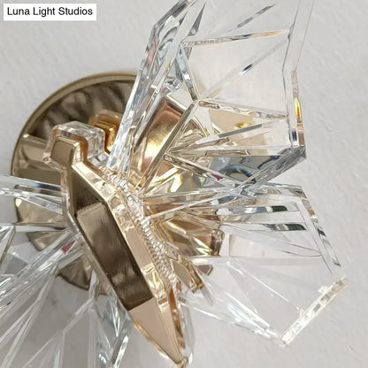 Luxury gold butterfly wall lamp with clear crystal chandelier featuring faceted geometric arms and metal base for bedroom lighting