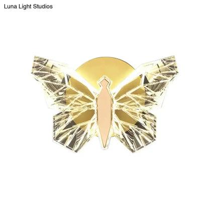 Luxury gold butterfly wall lamp with faceted crystal wings and illuminated body for elegant bedroom lighting