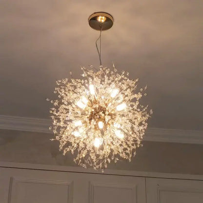 A luxury gold-toned decorbites dandelion chandelier with intricate crystal branches and multiple illuminated bulbs for living room light