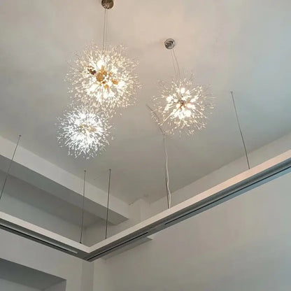 Three elegant gold-toned decorbites dandelion chandelier lights with clear crystal filaments for living room decor