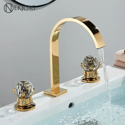 Luxury gold crystal handle basin faucet with decorbites crystal knob handles and a sleek arched mixer spout