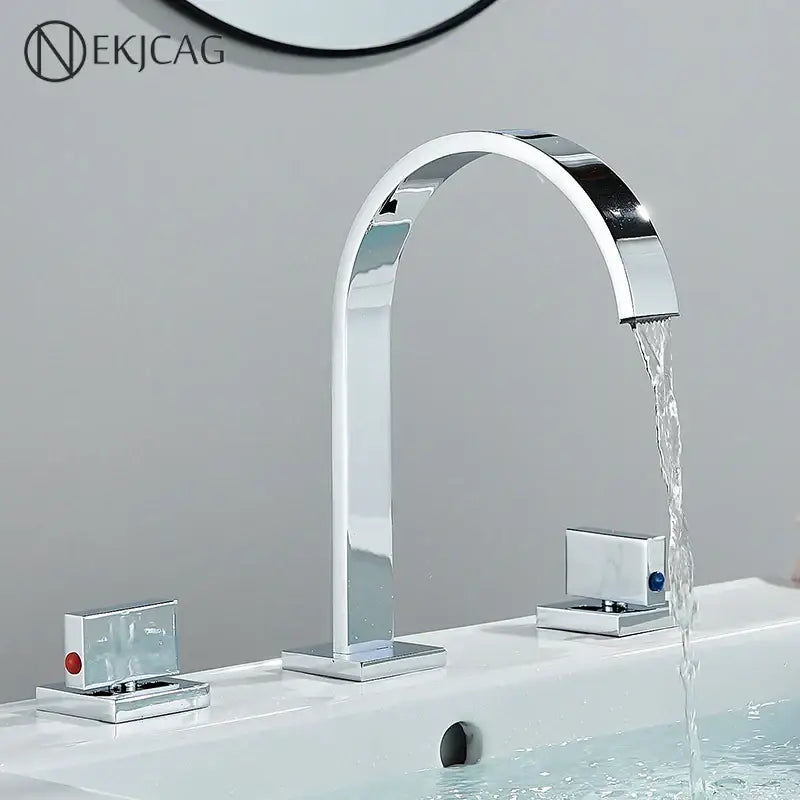 Chrome-finished basin faucet with sleek arched design and two rectangular decorbites crystal handle gold knobs