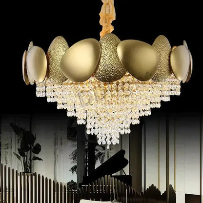 Golden egg-shaped led ceiling chandelier with textured metallic surfaces and cascading crystal tassels by decorbites lizzie