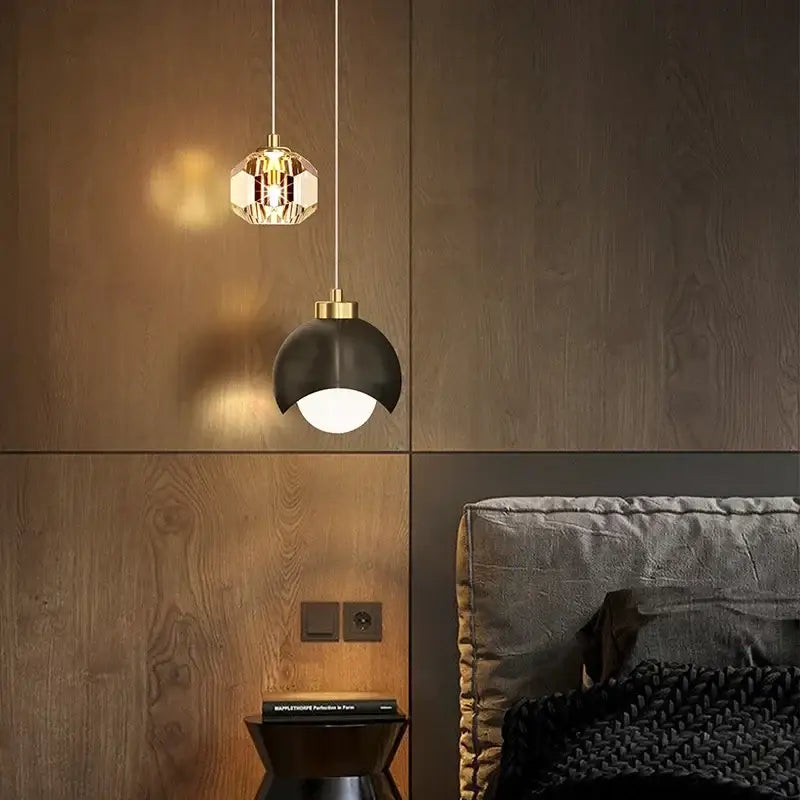 Two modern DecorBites LED pendant lights featuring faceted gold crystal and sleek black dome designs for luxury decor