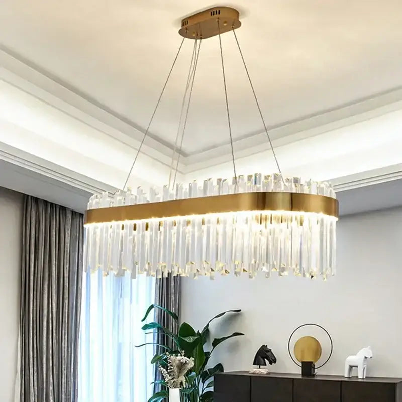 Luxury gold crystal pendant chandelier featuring gold-toned oval frame and clear crystal prisms decorbites crystal pendant