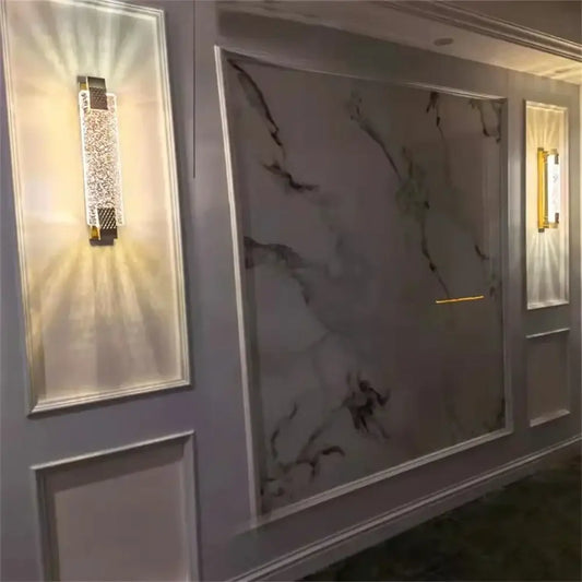 A sleek gold-toned crystal wall lamp with intricate decorbites crystal embellishments for living room lighting