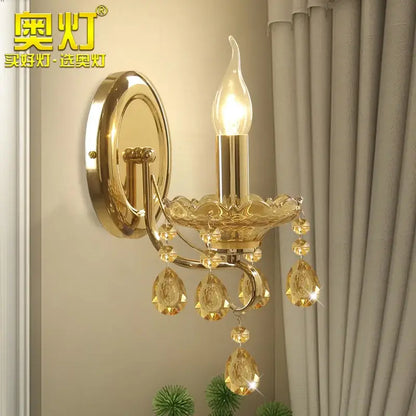Luxury gold crystal wall sconce with amber crystal droplets and candle-style bulb by decorbites crystal chandeliers