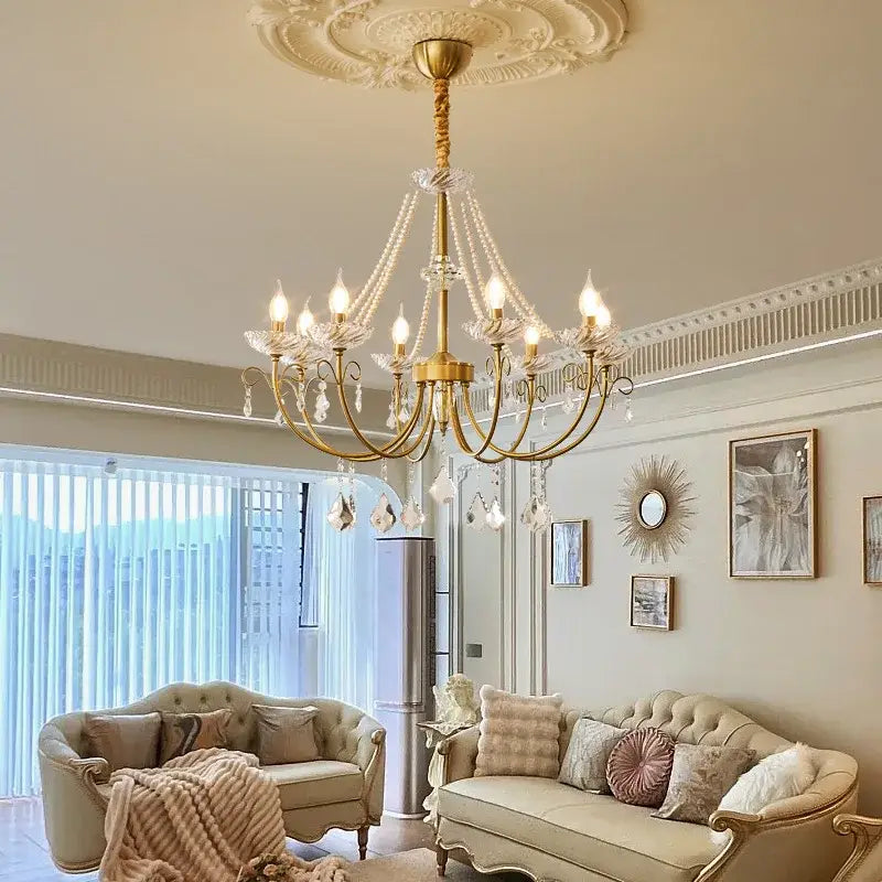 Luxury gold decorbites crystal led chandelier with ornate arms and crystal droplets hanging from decorative ceiling medallion