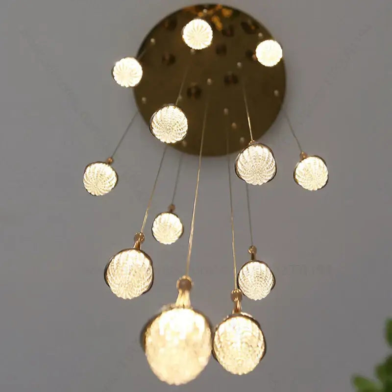 Luxury gold led staircase chandelier with gold-toned spherical textured glass globes by decorbites gold led decor