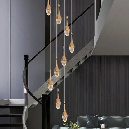 Luxury gold led staircase chandelier with gold teardrop-shaped crystal pendant lights for elegant living room decorbites gold led