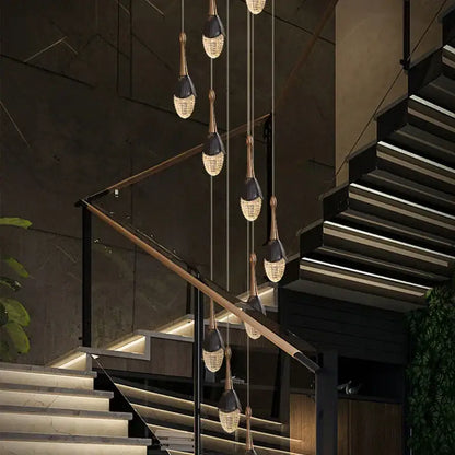 Luxury gold led staircase chandelier featuring modern black and gold pendant lights with crystal teardrop shades decorbites gold led