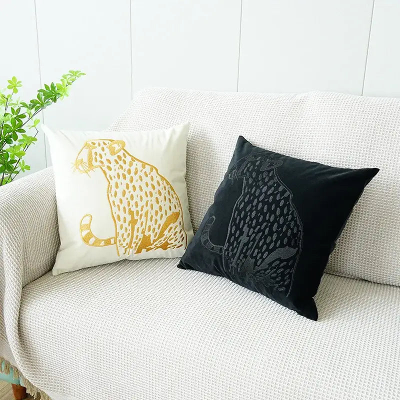 Two decorative throw pillow cases with decorbites gold leopard embroidery in cream and black velvet for living room decor