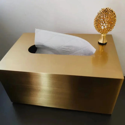 Luxury gold metal tissue box with deer figurine featuring a sleek brushed surface and open top showing white quilted tissues
