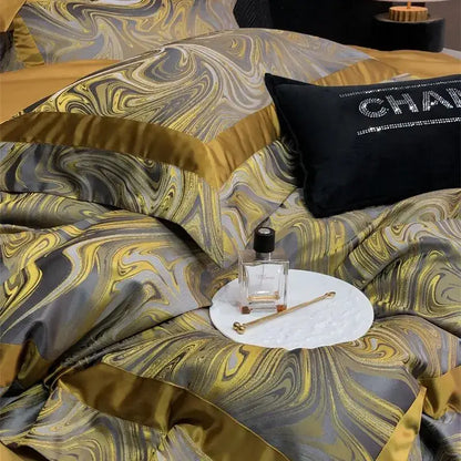 Luxury gold and gray marbled satin bedding set featuring black chanel pillow in decorbites brocade satin jacquard material