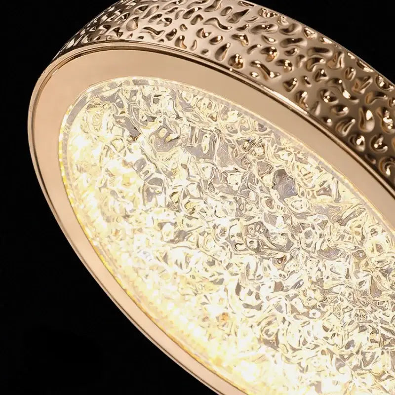 Luxury gold textured crystal ring pendant light with hammered metal frame and bubble patterned illuminated glass panel for decorbites crystal ring decor