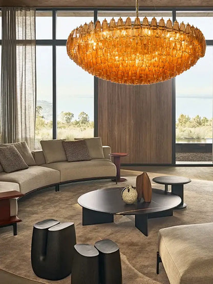 A large amber-colored decorbites gray glass chandelier with textured honeycomb design for dining room lighting