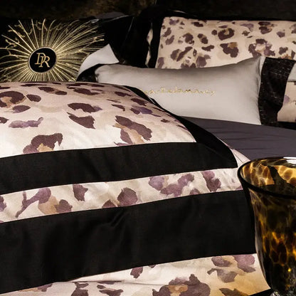 Luxury leopard print satin bedding set featuring a cream and black leopard print luxury duvet cover with gold embroidery