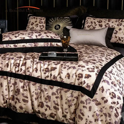 Luxury leopard print satin bedding set featuring a cream duvet cover with bold brown decorbites leopard print and black trim