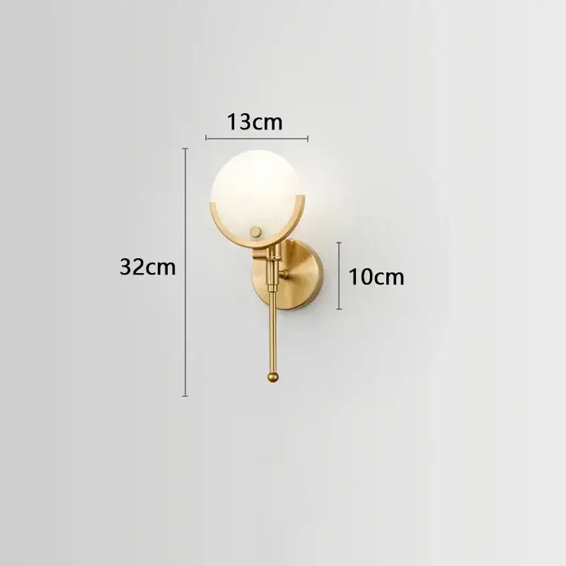 Luxury gold-toned copper wall lamp with frosted glass globe and slender stem for elegant bedroom lighting