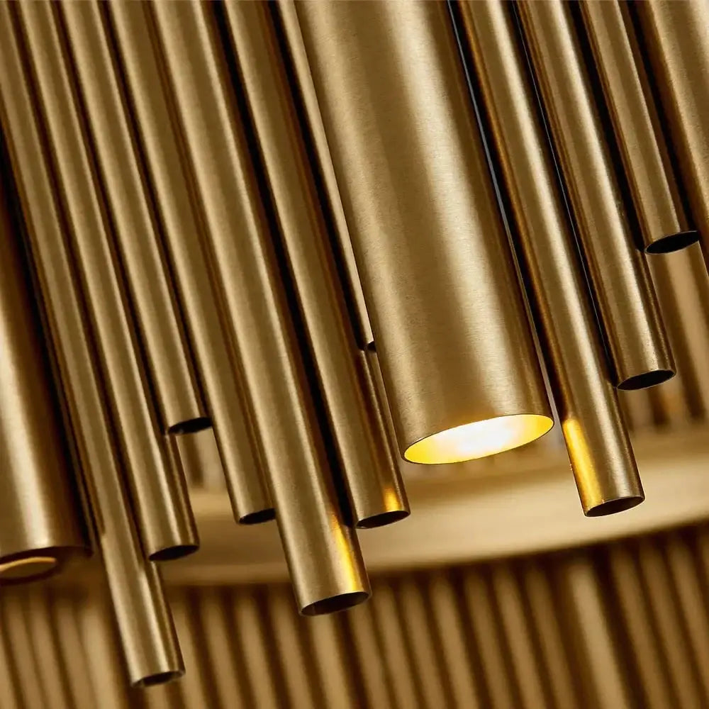 Modern brass tube pendant light with warm glowing illumination in luxury modern round gold chandelier for living room use