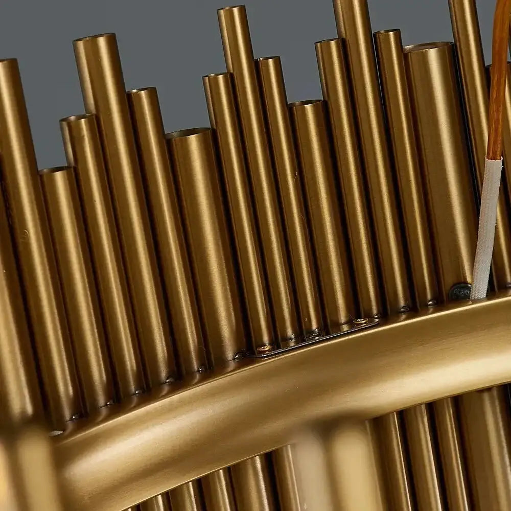 Golden metallic tubes arranged vertically in a luxury modern round gold chandelier for living room by decorbites maddison