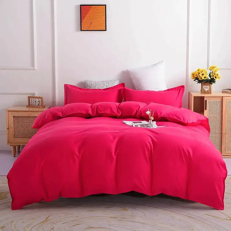Luxury vibrant fuchsia satin duvet cover set with matching pillowcases neatly arranged on bed for bedroom bedding