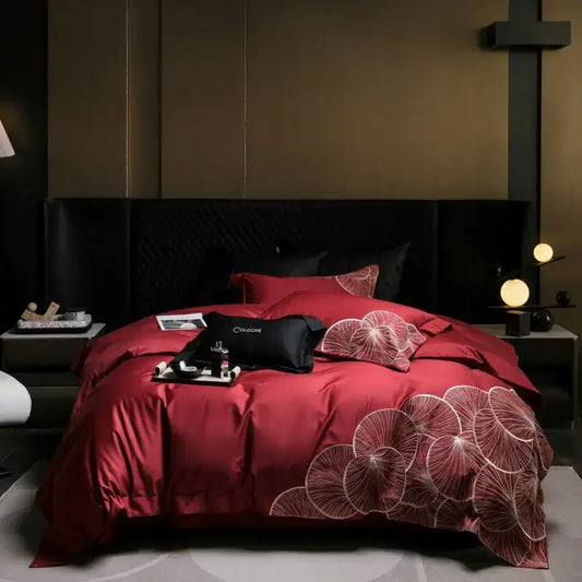 Luxury red satin duvet cover with white embroidered lotus patterns in a cotton bedding set for bedroom use