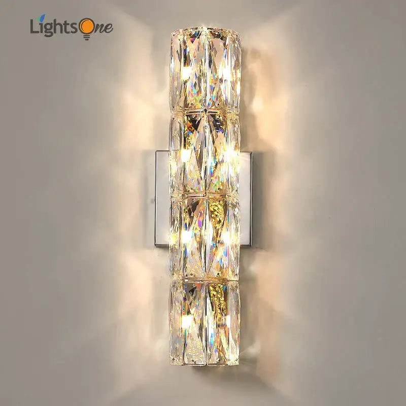 Luxury silver crystal deluxe wall sconce with faceted clear glass segments on a sleek metal plate for living room decorbites