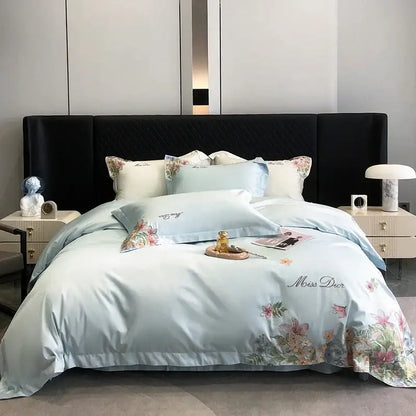 Light blue satin bedding set with delicate cotton flowers embroidery and miss dior logo in luxury bedroom style