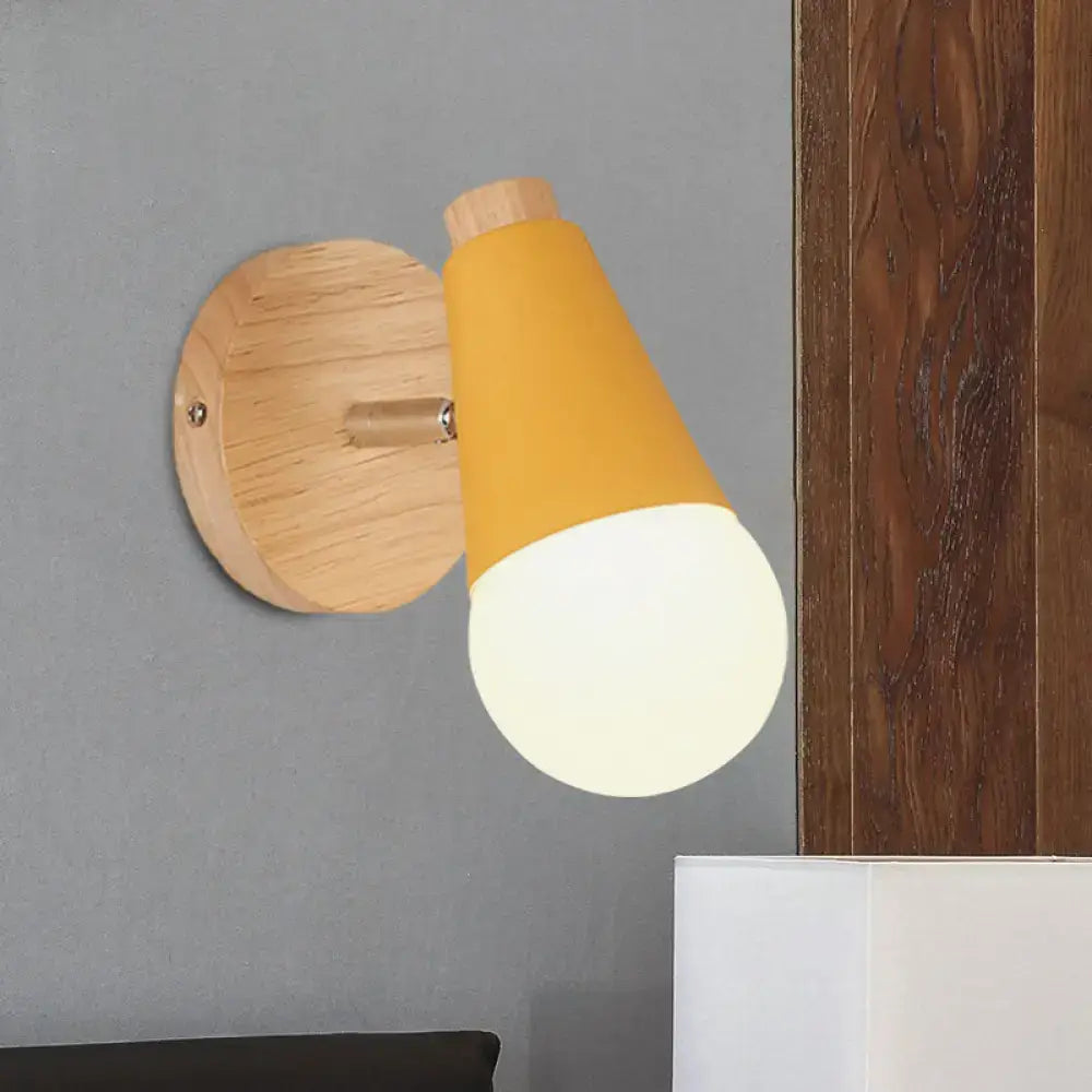A macaron loft sweet cone pink wall sconce with warm yellow shade and natural wood base for corridor lighting metal wood