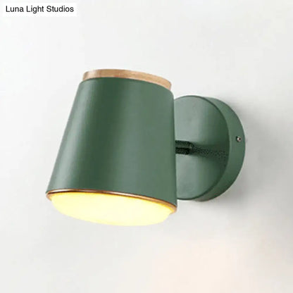 A sleek matte green wall lamp fixture with natural wood trim and cylindrical shade for bedroom wall light use
