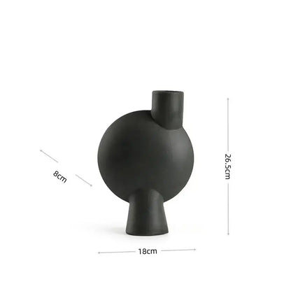 Matte black ceramic vase with rounded body short stem and cylindrical neck decorbites calla lily living room decor