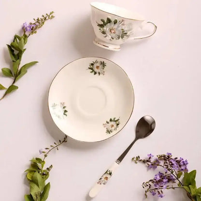 White bone china tea cup set with magnolia floral pattern, gold trim, and soft green accents by decorbites bone china