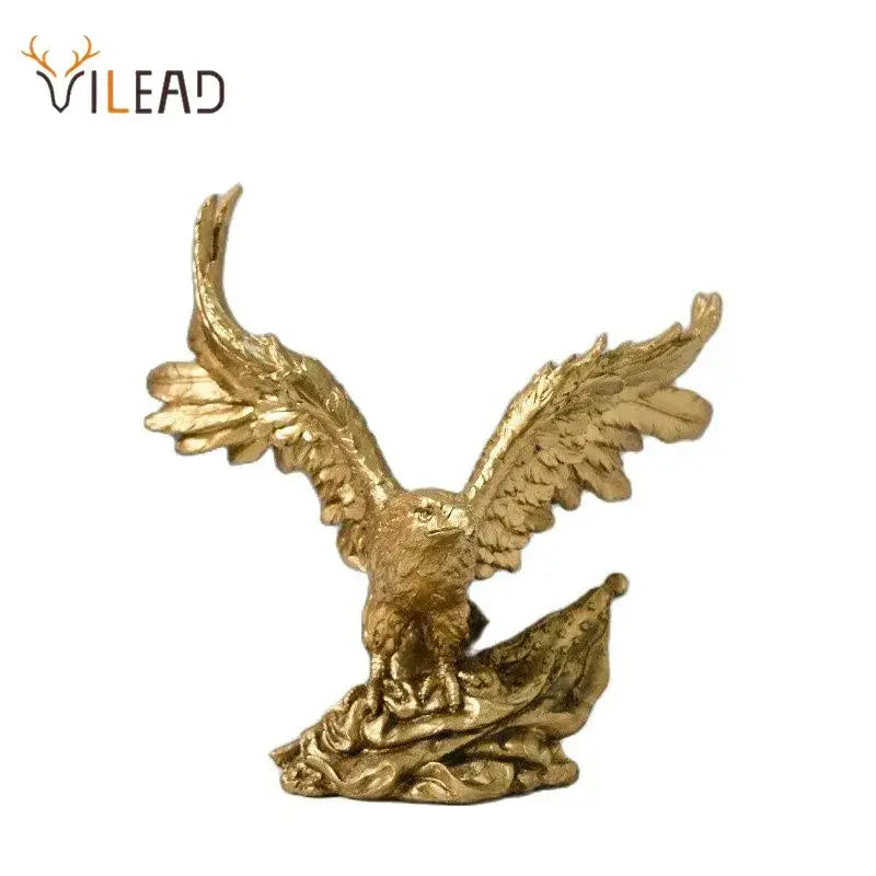 Majestic gold resin eagle sculpture with detailed feathered wings spread wide perched on textured base for decor