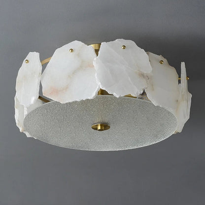 White translucent alabaster stone slices with veining arranged around frosted glass diffuser on marble led chandelier round pendant light