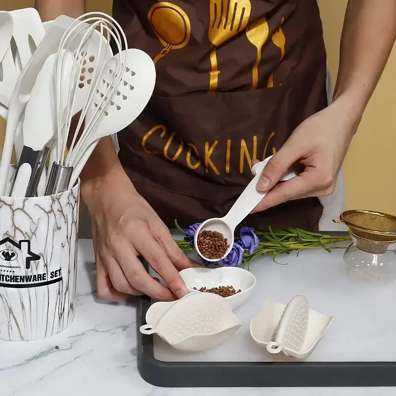 White silicone measuring spoon with smooth handle and shallow bowl from marble pink silicone cooking tool set for precise measurement