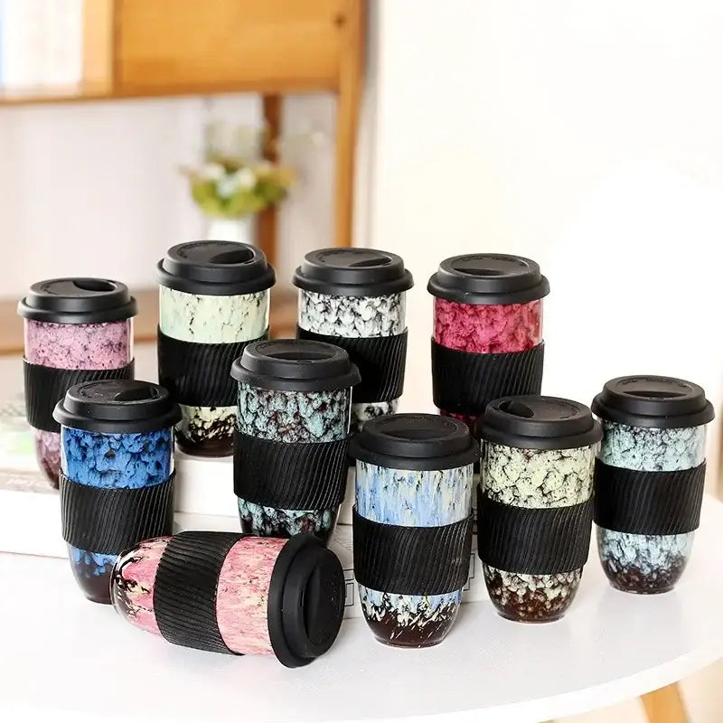 A collection of decorbites ceramic kiln ceramic kiln mugs with silicone grips and unique marbled patterns in various colors