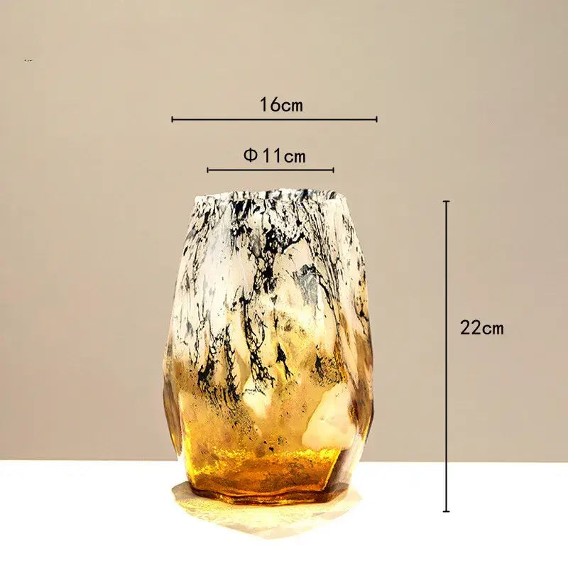 A tall black glass vase with marbled gold and black gradients and amber base for living room decorbites gradients black