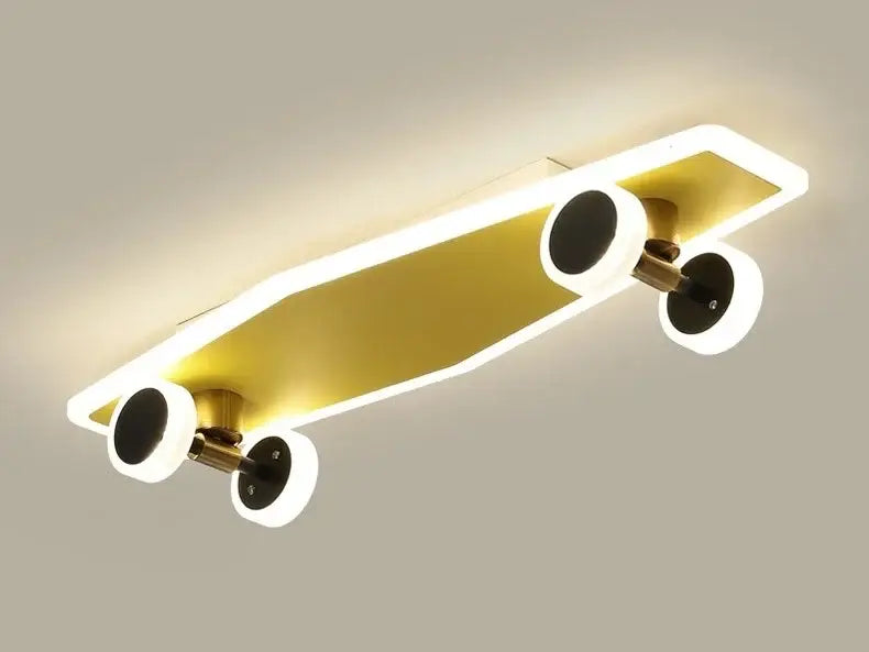 Gold-colored cartoon skateboard ceiling light with illuminated edges and black wheels for children room decorbites cartoon skateboard