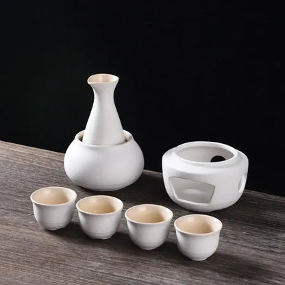 White ceramic sake set with slender-necked decanter four cups and insulated warmer from decorbites ceramic sake kit