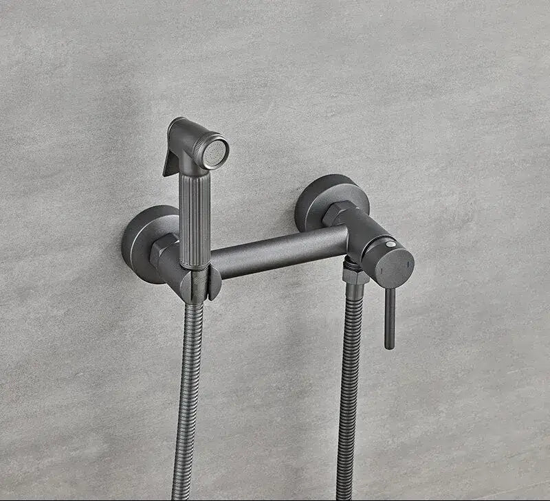 Matte black bidet faucet set with a modern minimalist design and two flexible metal hoses for bathroom use