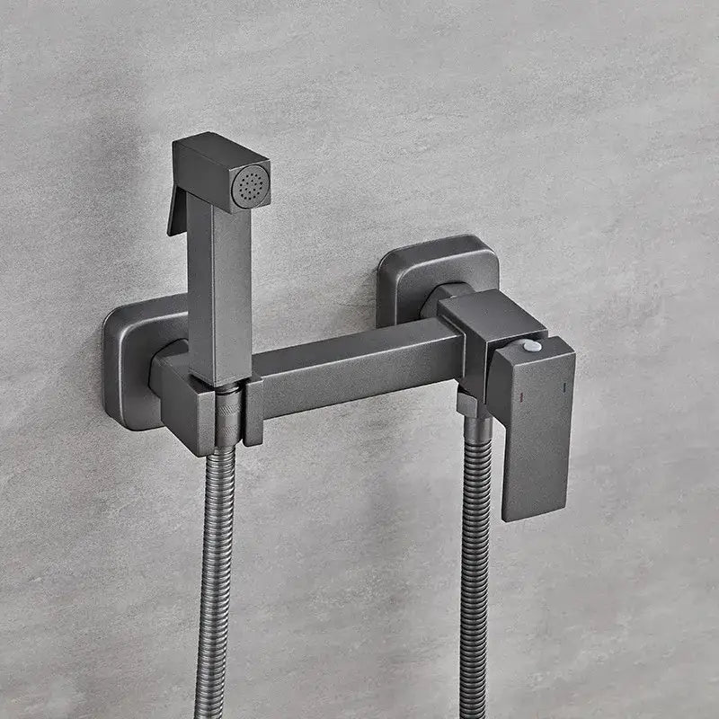 Modern matte black bidet faucet set with integrated handheld sprayer and flexible hoses for bathroom use