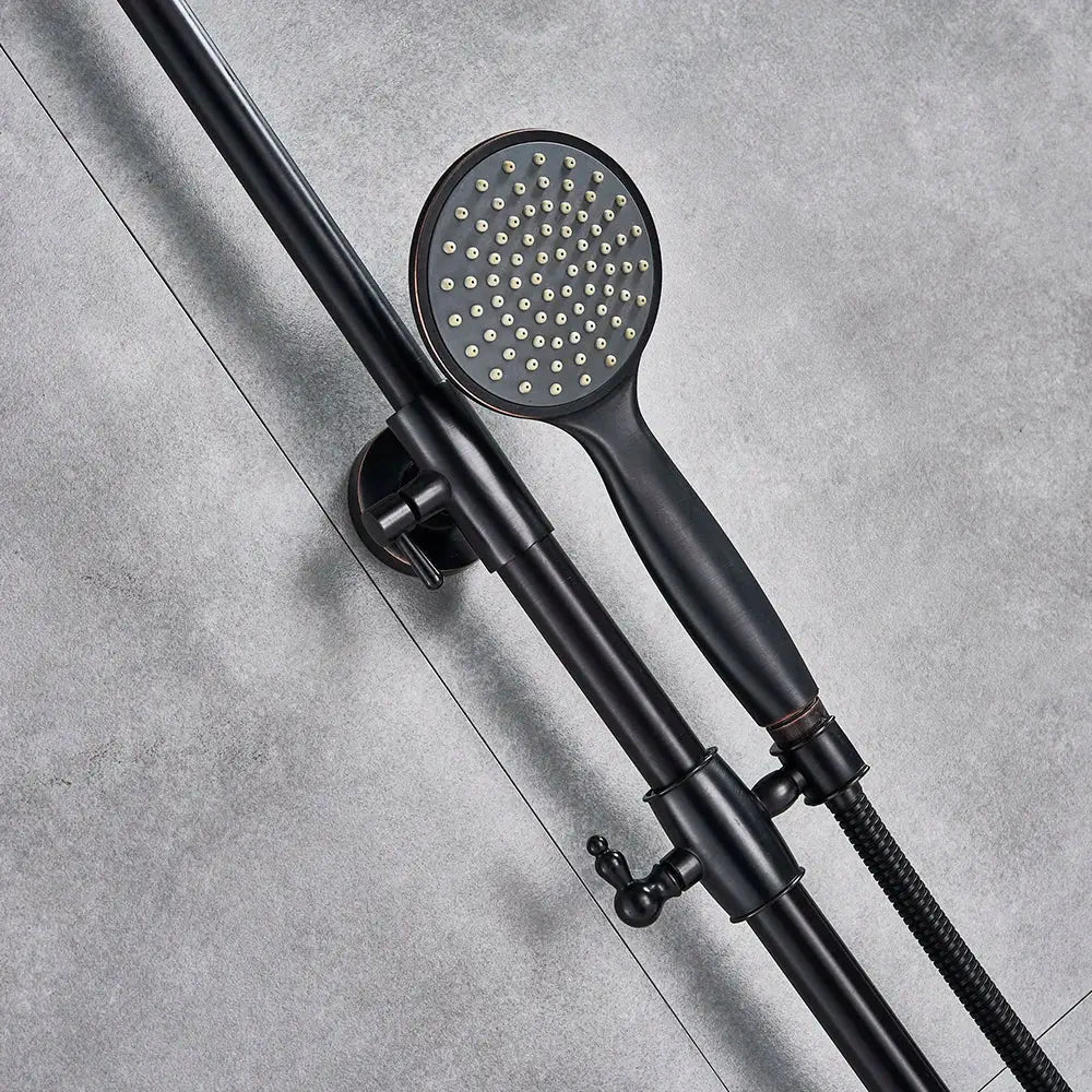 Matte black shower faucet set with bronze accents featuring a rain shower head and textured grip handle mounted on an adjustable bar