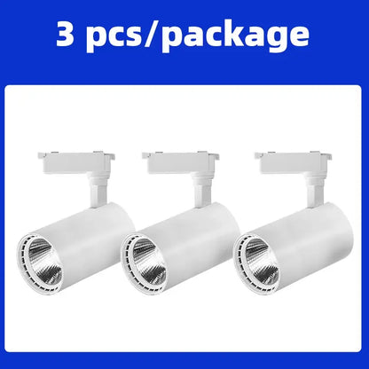 Three white cylindrical track lighting fixtures with adjustable heads for chandelier track ceiling by decorbites cob chandelier