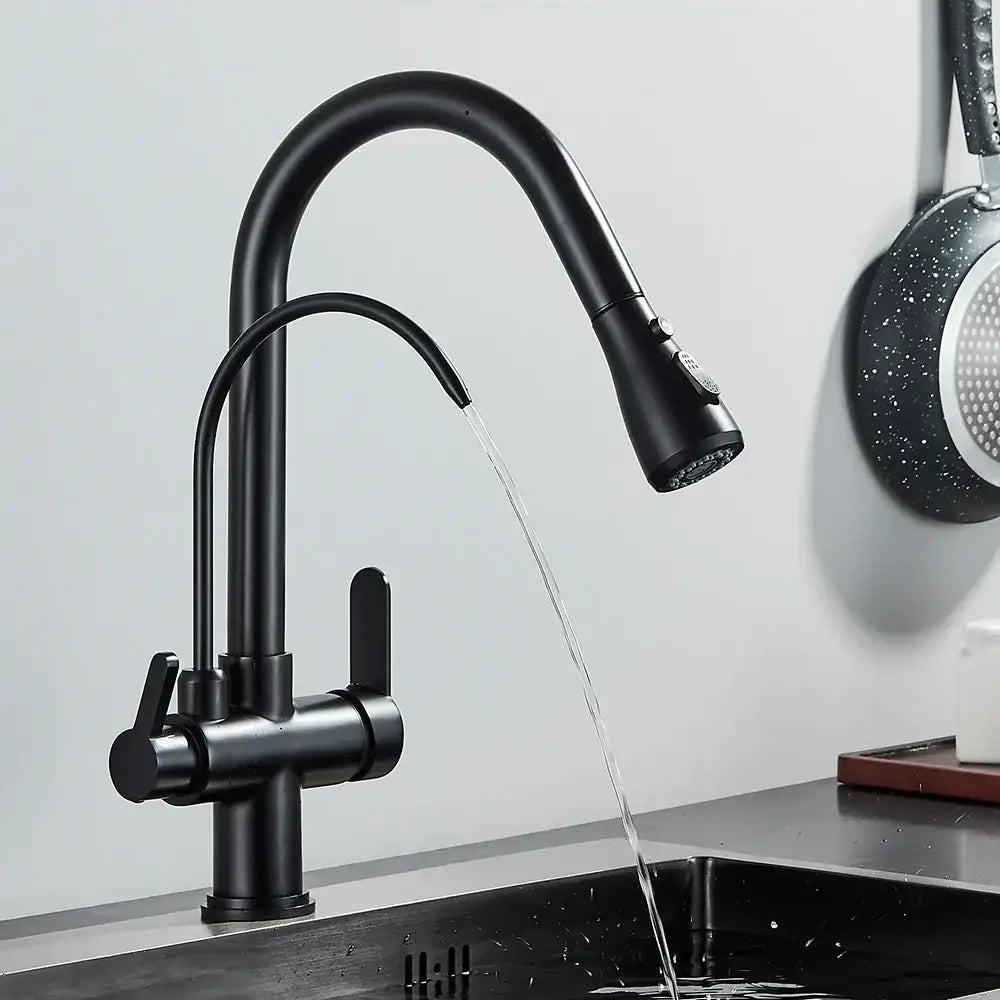 Black kitchen faucet with water flowing into a sink against a light gray wall.
