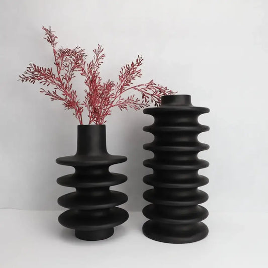 Two matte black ceramic vases with geometric circle spiral ridges and narrow neck for living room decor