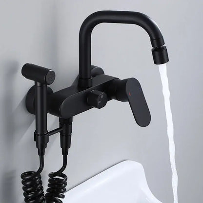 Matte black kitchen mixer tap with a curved spout and integrated handheld showerhead on a coiled hose